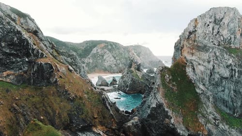 Amazing Flight Between the Rocks on the Ocean Coast to the Sandy Beach