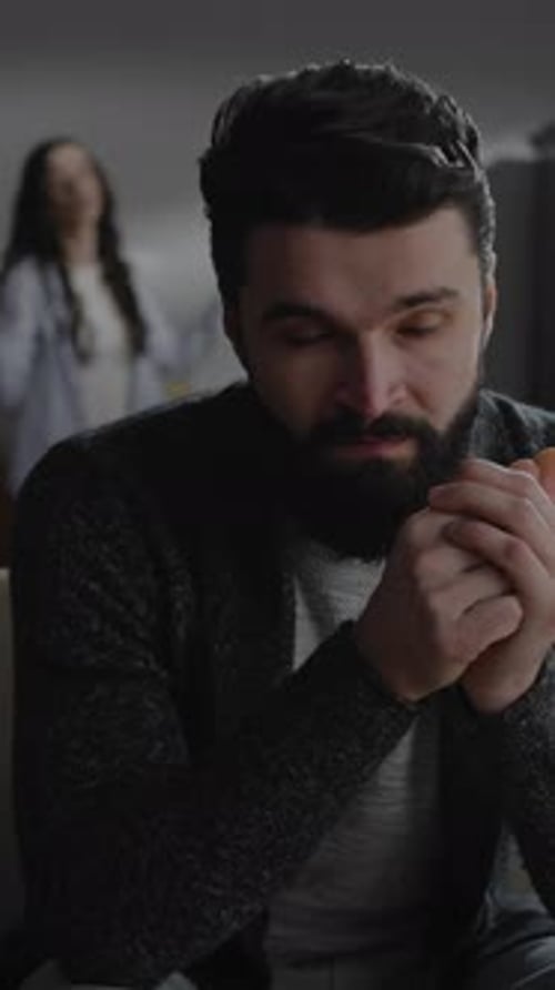 Man Looks Troubled as Woman Gestures Frustratedly