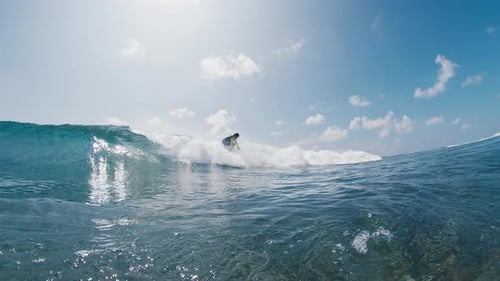 Surfer Rides the Wave in the Ocean in the Maldives
