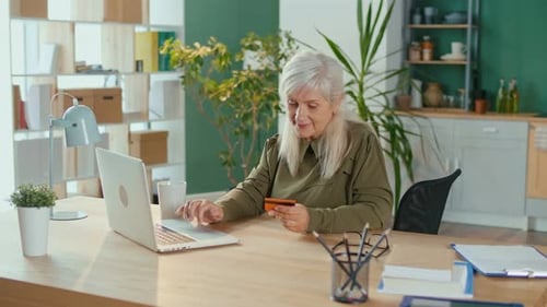 Senior Woman Shopping Online At Home