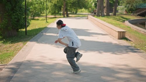 Asian Athlete Executing Swift Foot Maneuvers Outdoors City Street Artist Showcasing Agility
