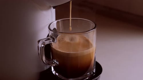 Coffee Maker Dispensing Coffee into Glass Mug