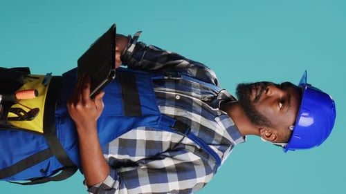 Vertical Video Confident Mechanic Using Tablet for Calculations