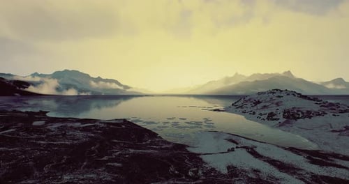 Serene Twilight Over a Tranquil Lake Surrounded By Majestic Mountains