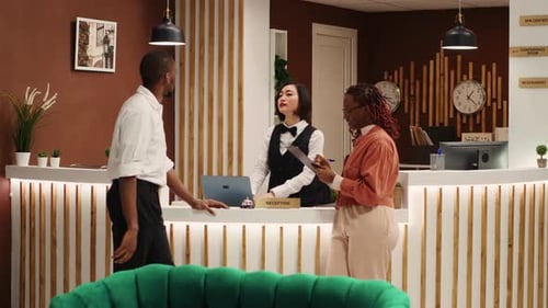 Hotel Reception Desk with Guests Checking In