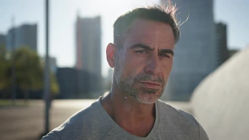 Close Up Portrait Serious Attractive Middle Aged Man Looking Concentrated at Camera Standing Outdoor