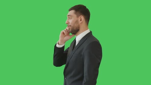 Medium Shot of a Serious-Minded Businessman Talking on the Phone While Camera Rotates around Him. H