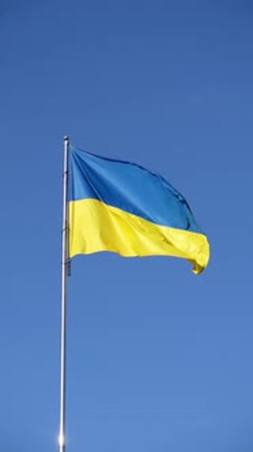 Ukraine Flag Waving Against a Blue Sky