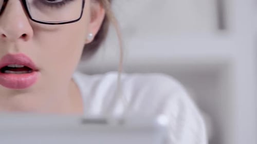 Attractive Young Blonde Woman Using Tablet Computer Touchscreen