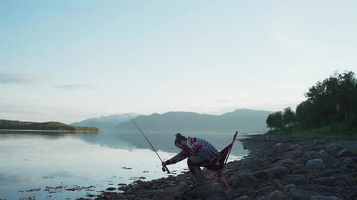 Vangsvik, Senja, Norway - A Man Getting Ready for a Fishing Adventure Beside the Lake - Static Shot