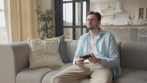 Man Relaxing on Couch Playing Video Game