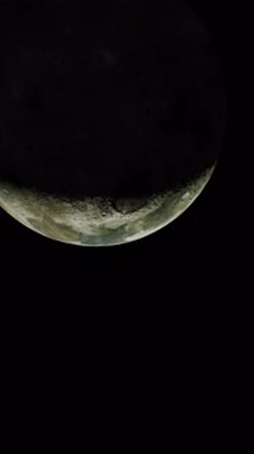 Moon's Partially Sunlit Surface in View From Above Vertical