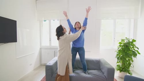 Two Women Exercising Together at Home
