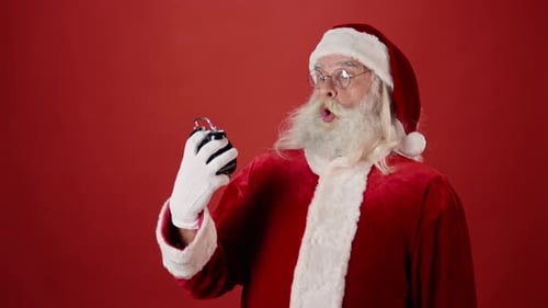 Santa Claus Pointing to Midnight and Leaving with Bag of Gifts