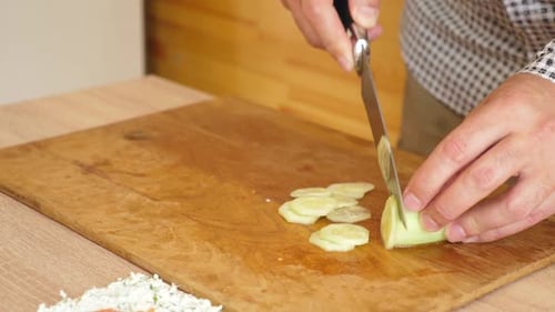 Slicing Cucumber on Cutting Board, Close Up