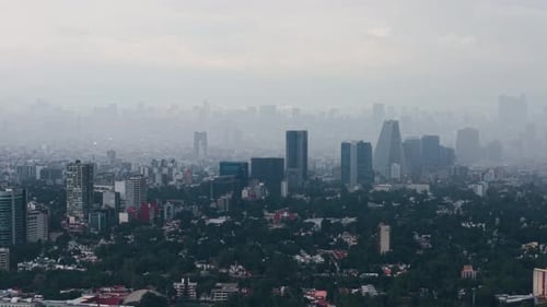 Heavy rainfall over Mexico City during a rainy evening, film drone
