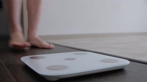 Man On Scales Measure Weight