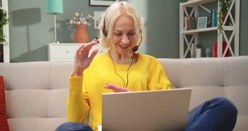 Woman Video Calling Using Laptop in Living Room