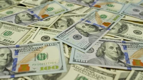 Closeup of Hundred Dollar Bills Lying on the Banker's Desk