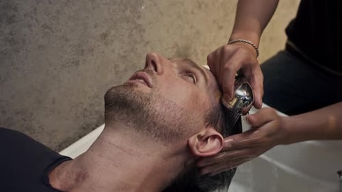 Man Relaxing, Having His Hair Shampooed in Salon