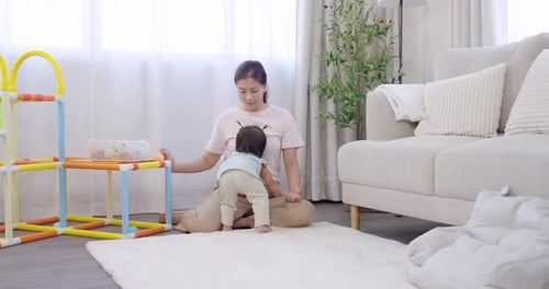 Woman and Baby Playing with Toys in Living Room