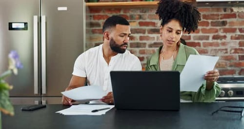 Couple Working on Finances in Kitchen with Laptop
