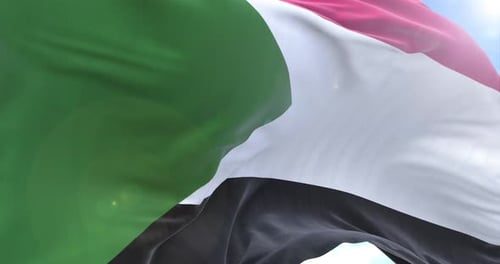 Sudan National Flag Waving Seamlessly Against Bright Blue Sky