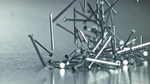 Bright Nails Flung Across Textured Surface with Cool Tones Filmed on a Highspeed Camera at 1000 Fps