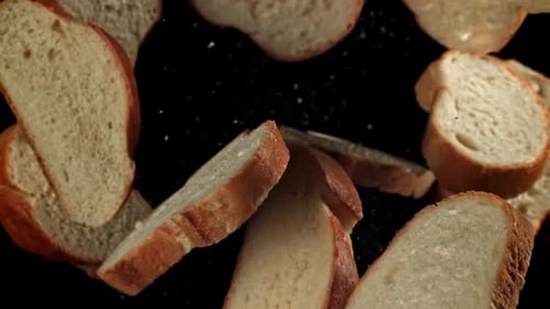 Slow Motion Bread Slices Floating on Black Background