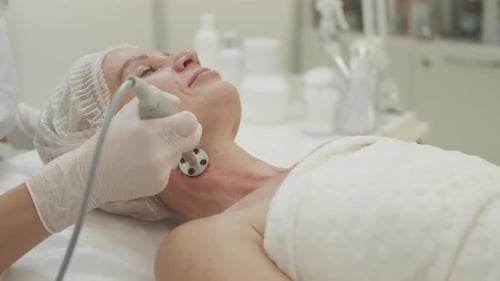 Mature Woman Receiving Facial Treatment at Spa