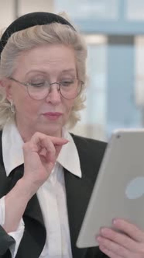 Woman Works On Tablet In Office Setting