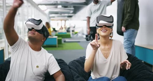 Young Adults Using VR Headsets in Modern Office