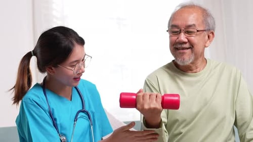 Senior Man Exercising with Health Professional at Home