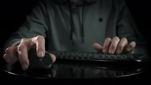 Hands Typing on Keyboard in Dark Environment