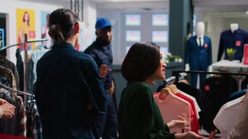 Shoppers Browsing Clothing in Modern Retail Store