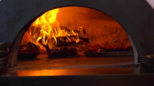 Wood Fired Oven Roasting Food with Burning Flames