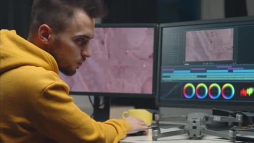 Freelance Videographer Colorist Editing Footage Using Professional Software Monitor and Montage