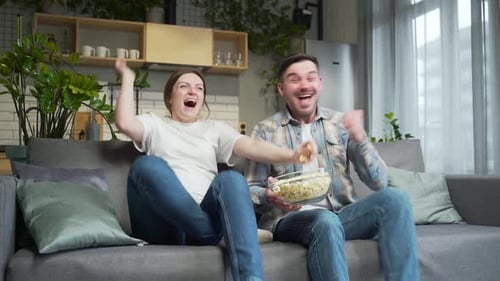 Excited Couple Watching Sports at Home
