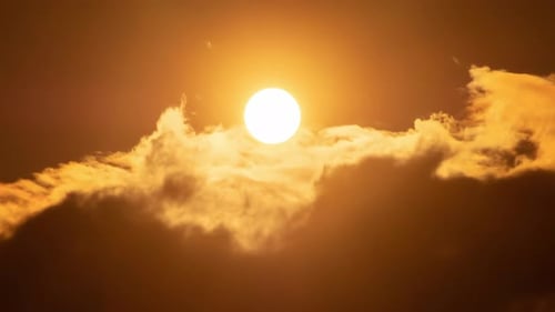Sun Rises Behind the Dark Clouds in Time-Lapse