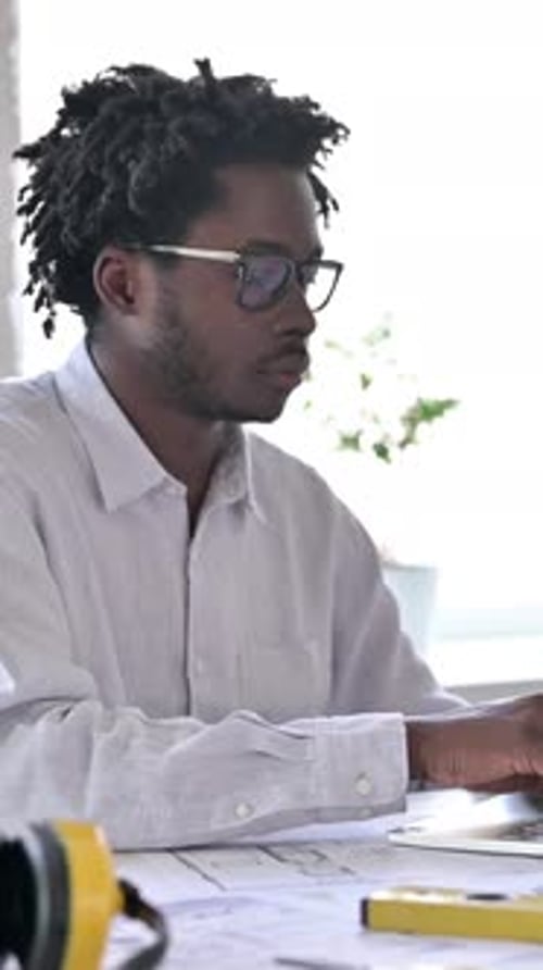 Young Man Works on Laptop Gives Thumbs Up