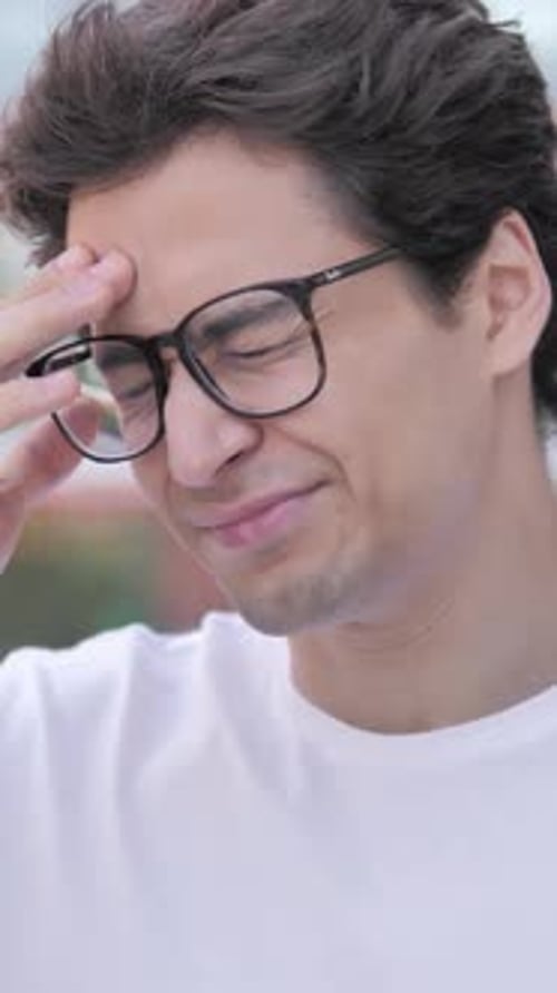 Outdoor Portrait of Man with Headache, Pain, Vertical Video