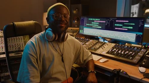 Portrait of Smiling African American Male Audio Engineer Posing in Studio