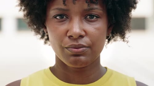 Portrait of a Young Black Woman Looking to the Camera with Calm and Serious Expression