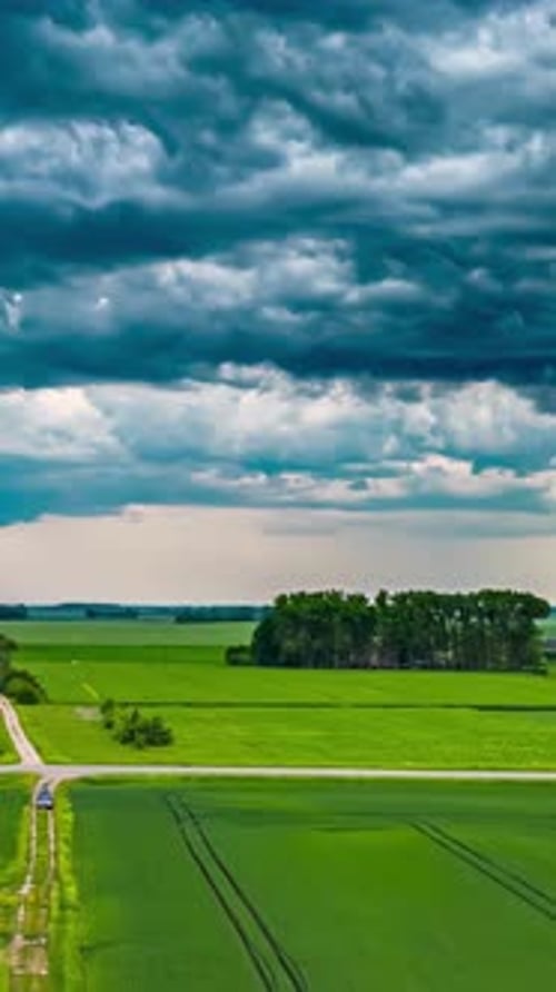 Dramatic storm clouds roll across the sky in vibrant shades of blue and white, hyperlapse footage