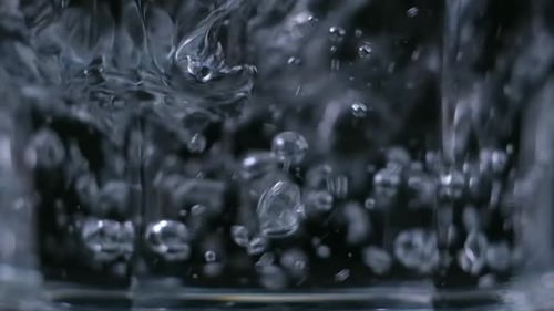 Liquid Poured Into Clear Glass With Bubbles