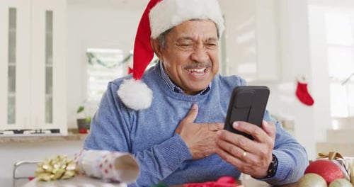 Man in Santa Hat Video Calling on Mobile