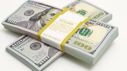 Stack of Bank Bundles with US Dollars on a White Background Closeup Shot of New Freshly Printed