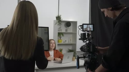 The Crew Backstage Female Producer Cameraman with Camera n the Studio During Filming A Female