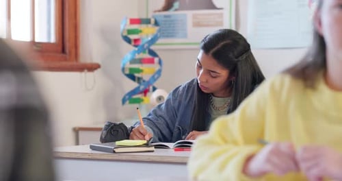 Student, girl and writing notes in high school, learning and study in classroom