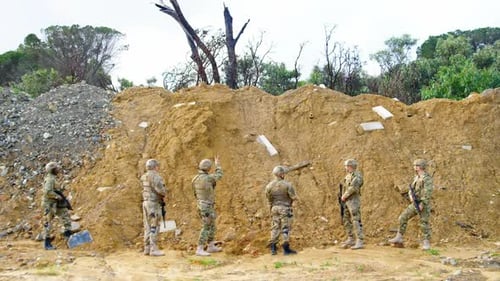 Rear view of Biracial military soldiers rifle training in fields during military training 4k